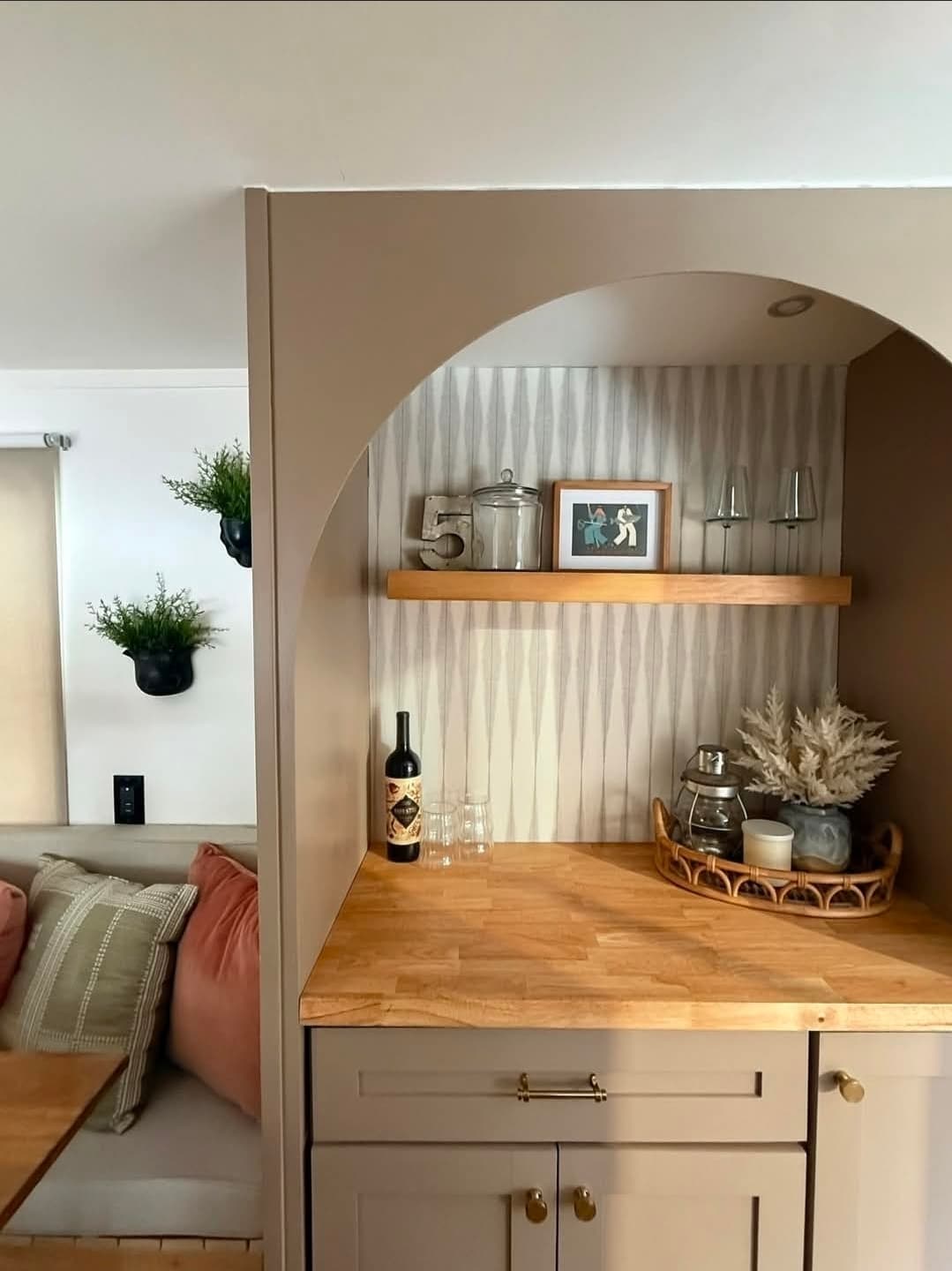 Val's renovated counter and beverage nook with open shelving and glassware.